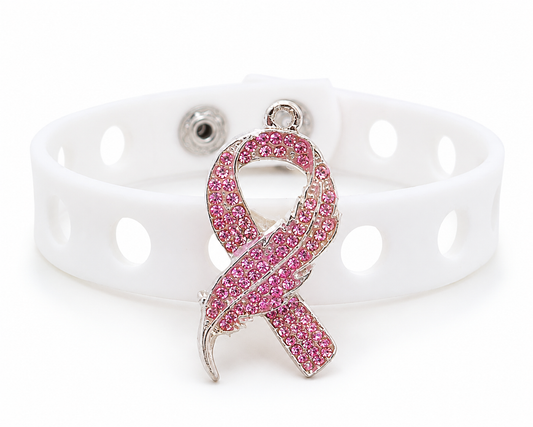 💖 Elegant pink awareness bracelet featuring a sparkling rhinestone ribbon charm and adjustable white silicone band. Stylish, inspiring, and perfect for everyday wear.