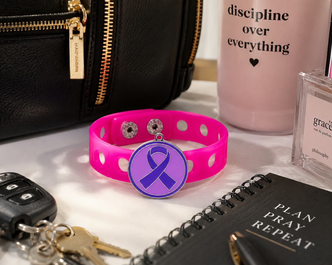 💜 Stylish pink silicone awareness bracelet featuring a purple ribbon charm. Lightweight, adjustable, and perfect for everyday inspiration and support.