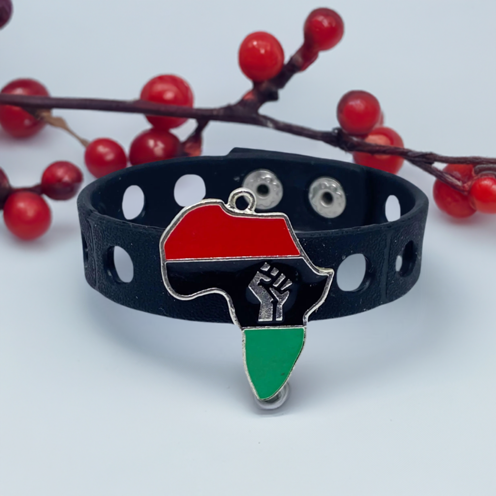 A charm bracelet featuring the outline of Africa in vibrant black, red, and green colors, with a raised power fist symbol in the center. The bracelet embodies African pride and solidarity."