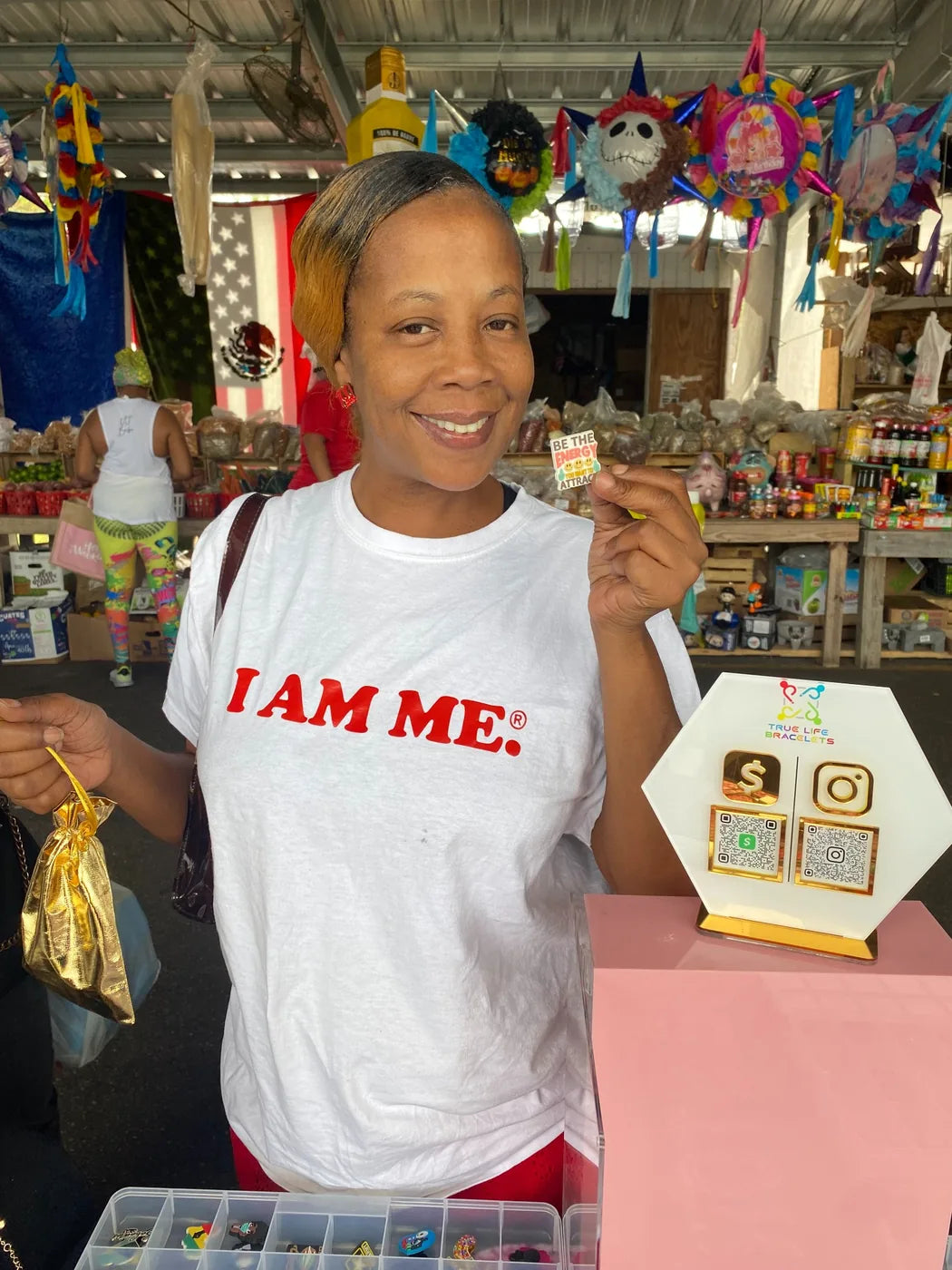 Customer holding Be The Energy bracelet charm at marketplace