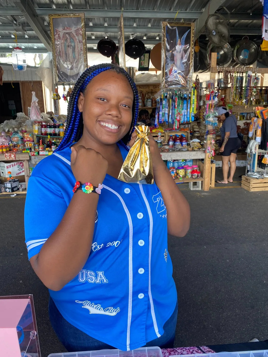 Young customer wearing a charm bracelet and holding gift bag