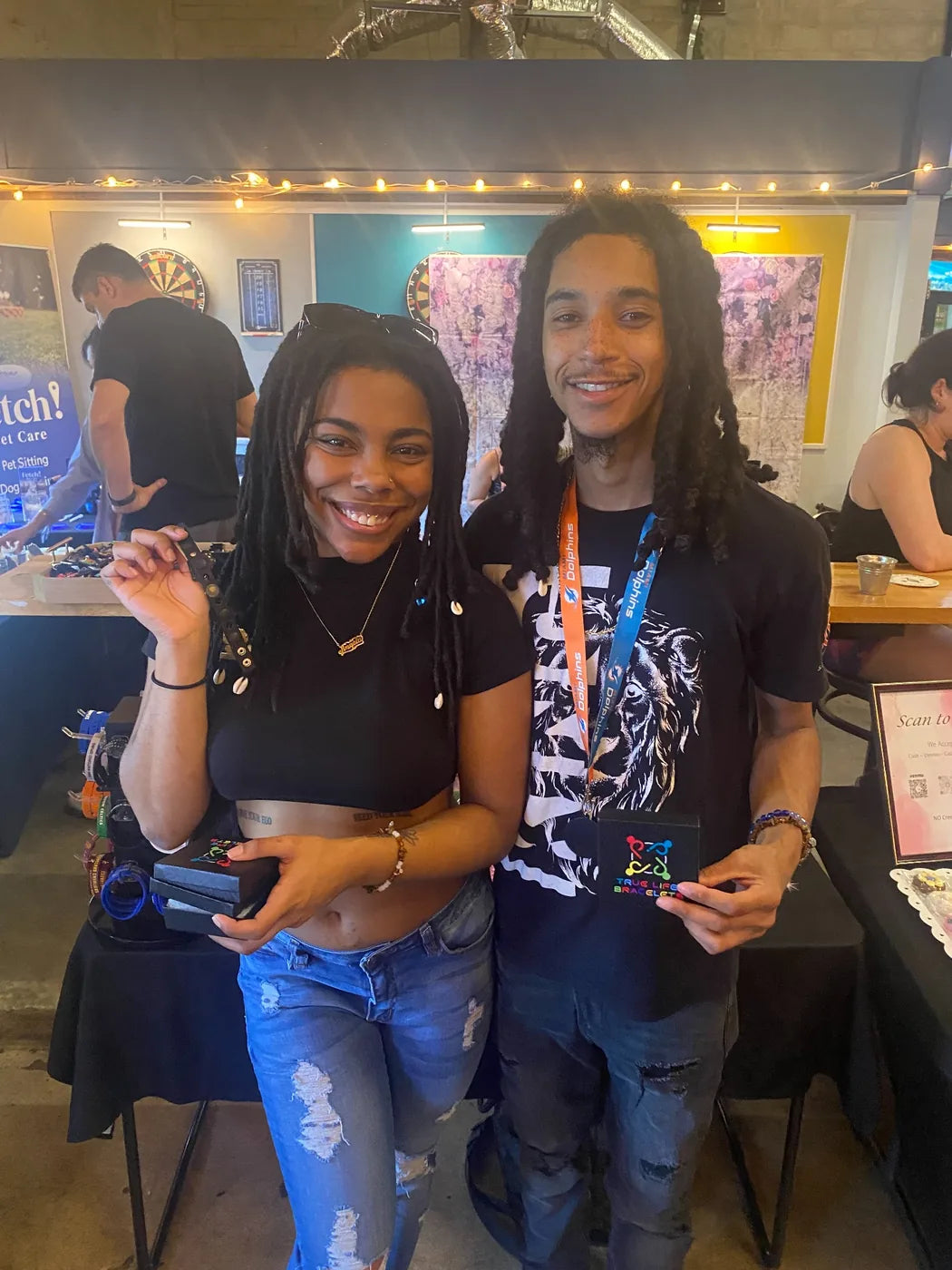 True Life Bracelets customers smiling with product boxes